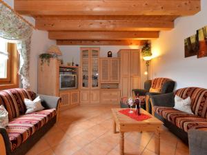 a living room with two couches and a table at holiday house in the Bavarian Forest in Drachselsried
