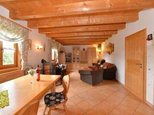 a kitchen and living room with a wooden ceiling at holiday house in the Bavarian Forest in Drachselsried