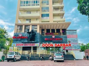 a building with cars parked in front of it at The Starfish Studio in Dehradun