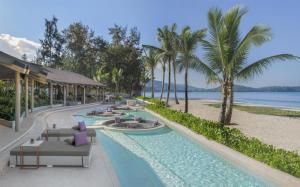a rendering of a resort pool with palm trees and a beach at Banyan Tree Phuket in Bang Tao Beach