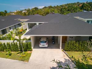 a car parked in the driveway of a house at Valentine Village in Choeng Mon Beach