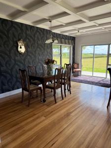 a dining room with a table and chairs at The King's Rest in Matamata