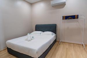 a small bedroom with a bed with a blue headboard at KT Seaview City Suite in Kuala Terengganu +34 photos