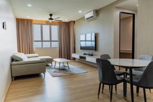 a living room with a table and a couch at KT Seaview City Suite in Kuala Terengganu
