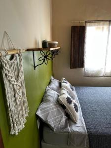 a bedroom with a bed and a shelf on the wall at Casa Esmeralda in Lençóis +7 photos