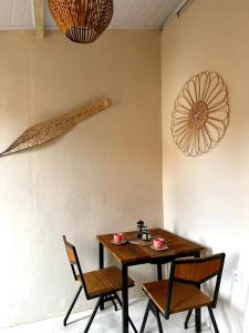 a dining room table with two chairs and a table and two utensils at Casa Esmeralda in Lençóis