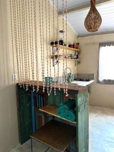 a kitchen with a table and a counter with chains at Casa Esmeralda in Lençóis
