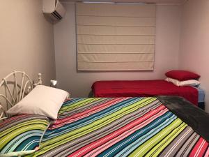 a bedroom with two beds and a window at York - Mulyinjinin Valley Cottage in York