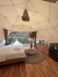 a bedroom with a bed and a large tent at Naima 2 in Panjadakan