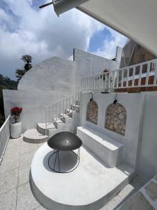 a black stool sitting on a patio with stairs at Naima 2 in Panjadakan