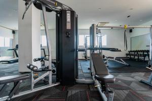 a gym with several tread machines in a room at KT Seaview City Suite in Kuala Terengganu