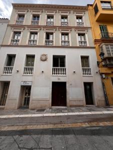 a large white building with windows and a door at Beautiful Apartment Teatro Cervantes in Málaga