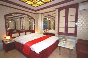 a bedroom with a large bed and a mirror at ホテルサティス伊勢店 in Ise