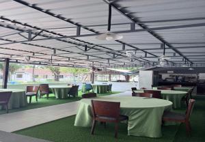 a dining area with tables and chairs at Hotel Green Town Port Dickson in Port Dickson