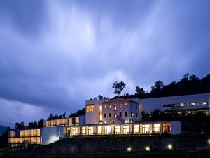 a large building with its lights on at night at Douro Palace Hotel Resort & SPA in Baião