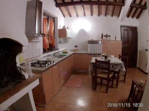 a kitchen with a table and a stove top oven at Villa Milù in Spoleto