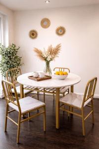 a dining room with a table and chairs with a bowl of fruit at Excellent 2 bedroom Apartment- great Connectivity to central london in Barking