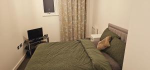 a bedroom with a bed and a television in it at Excellent 2 bedroom Apartment- great Connectivity to central london in Barking