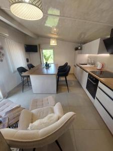 a kitchen and living room with a couch and a table at Ester in Kastav