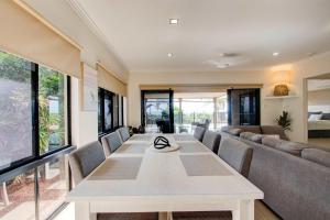 a living room with a table and a couch at Le Reve Wake up to sunrises and tropical breezes in Mission Beach