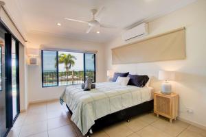 a bedroom with a bed with a view of the ocean at Le Reve Wake up to sunrises and tropical breezes in Mission Beach +23 photos