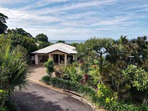 a house with a lot of trees and plants at Le Reve Wake up to sunrises and tropical breezes in Mission Beach