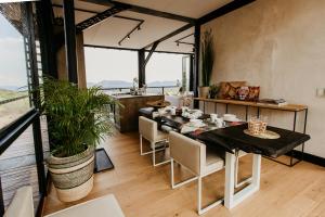 a dining room with a table and chairs at Cypiro Leopard Lodge in Kransberg