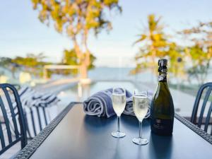 a bottle of champagne and two glasses on a table at Bella Luna Beach Front 2 bed in South Mission Beach
