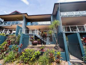 an apartment building with plants in front of it at BHA 4 Beachfront Bliss 2 bed in Mission Beach