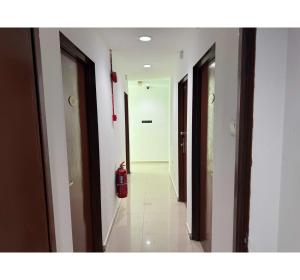 a hallway with a fire hydrant in a building at OYO 91288 Hotel PARADISE BATU CAVES in Batu Caves