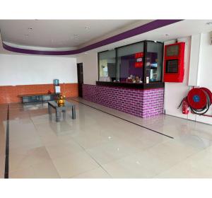 a restaurant with a red brick wall and a counter at OYO 91288 Hotel PARADISE BATU CAVES in Batu Caves