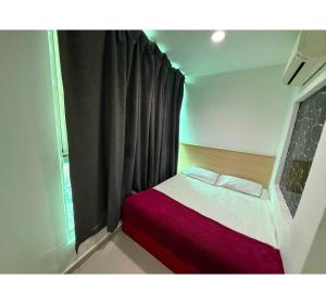 a small bed in a room with a window at OYO 91288 Hotel PARADISE BATU CAVES in Batu Caves