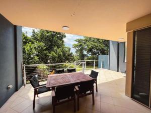 a table and chairs on a balcony with a view at BHA 4 Beachfront Bliss 2 bed in Mission Beach