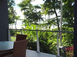 a balcony with a table and chairs and a view of the ocean at BHA 1 Beachfront Haven fullhouse in Mission Beach +10 photos