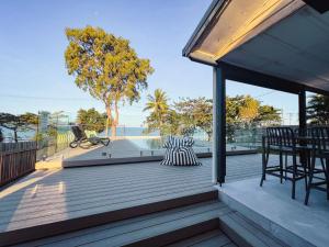 a large deck with a table and chairs on it at Bella Luna Beach Front Full house in South Mission Beach