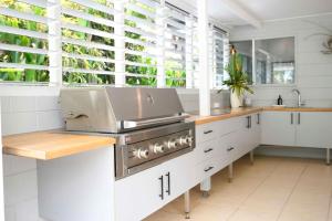 a kitchen with white cabinets and a stove at Tide Pool Ocean Front 2 bed in South Mission Beach