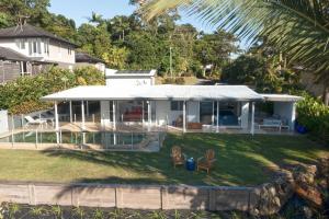a large white house with a large yard at Tide Pool Ocean Front 2 bed in South Mission Beach +42 photos
