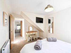 a bedroom with a bed and a desk at Heron View in Kirkcudbright