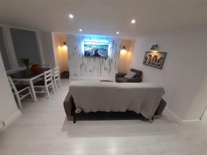a bedroom with a bed and a table in it at Cottage Apartment - Uk2774 in Llandudno