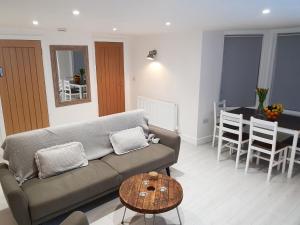 a living room with a couch and a table at Cottage Apartment - Uk2774 in Llandudno
