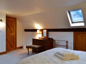 a bedroom with a bed with towels on it at The Stable - 31240 in Kilmartin +4 photos