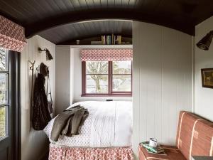 a bedroom with a bed and a window at Lapwing Shepherds Hut - Uk7631 in Pitlochry