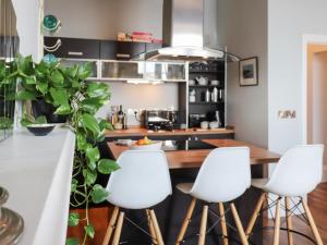 a kitchen with white stools and a kitchen counter at Seaside Apartment-Uk2801 in Aberystwyth