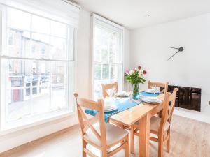 a dining room with a wooden table and chairs at The Kings in York