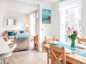 a living room with a table and a dining room at The Kings in York