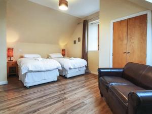 a living room with two beds and a couch at The Stables - Uk7791 in Milton of Auchinhove