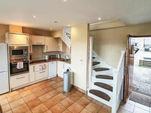 a kitchen with a spiral staircase in a kitchen at The Stables - Uk7791 in Milton of Auchinhove