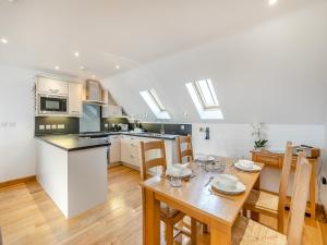 a kitchen and dining room with a table and chairs at 23 Mount Brioni in Downderry