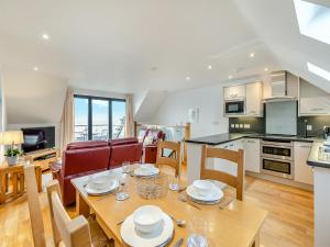 a kitchen and dining room with a table and chairs at 23 Mount Brioni in Downderry