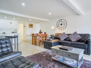a living room with a couch and a table at Imperial Apartment in Oban